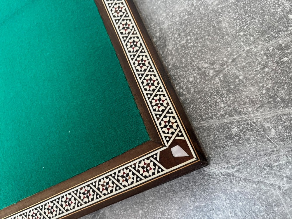 A wooden folding chess board featuring geometric inlaid borders and a full set of light and dark Staunton style chess pieces. View XIII