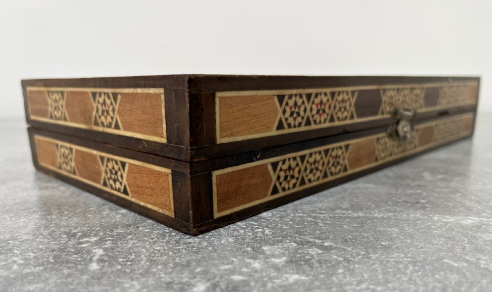 A hinged wooden folding games board featuring intricate geometric micro-mosaic marquetry and mother-of-pearl star motifs. View III
