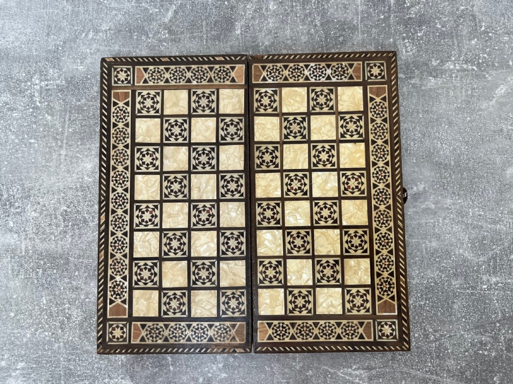 A hinged wooden folding games board featuring intricate geometric micro-mosaic marquetry and mother-of-pearl star motifs. View IV