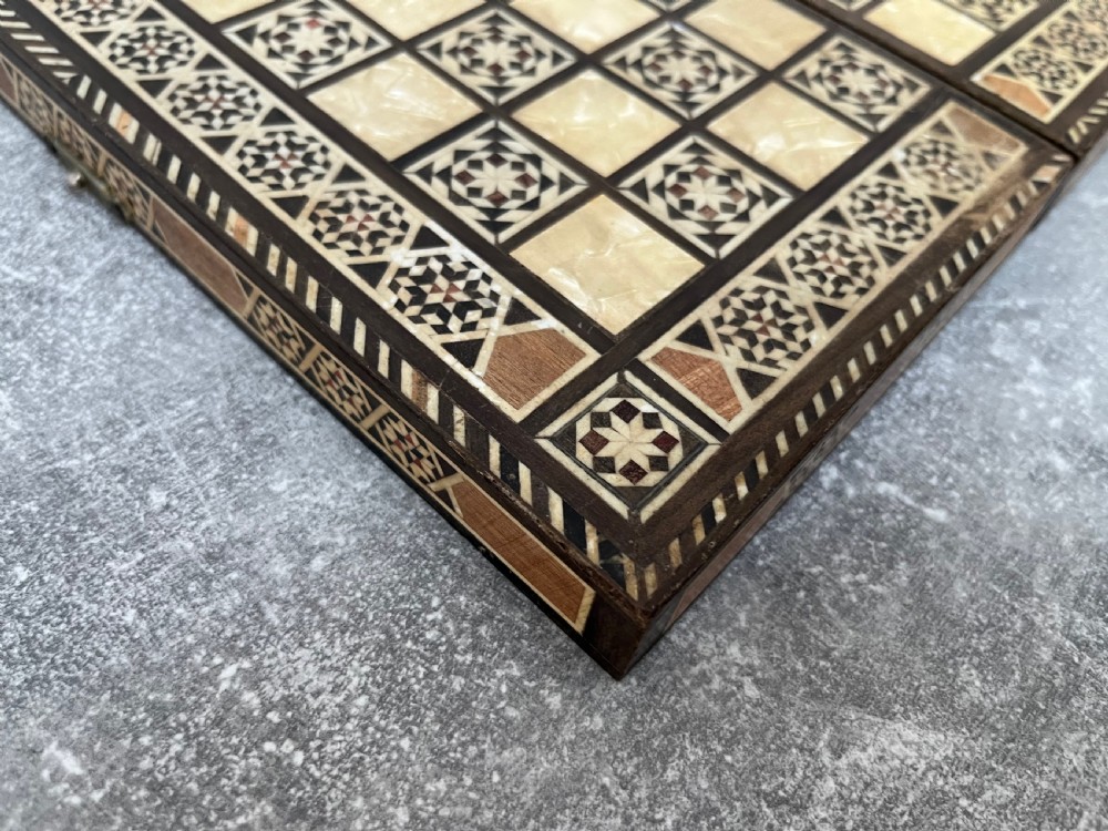 A hinged wooden folding games board featuring intricate geometric micro-mosaic marquetry and mother-of-pearl star motifs. View VI