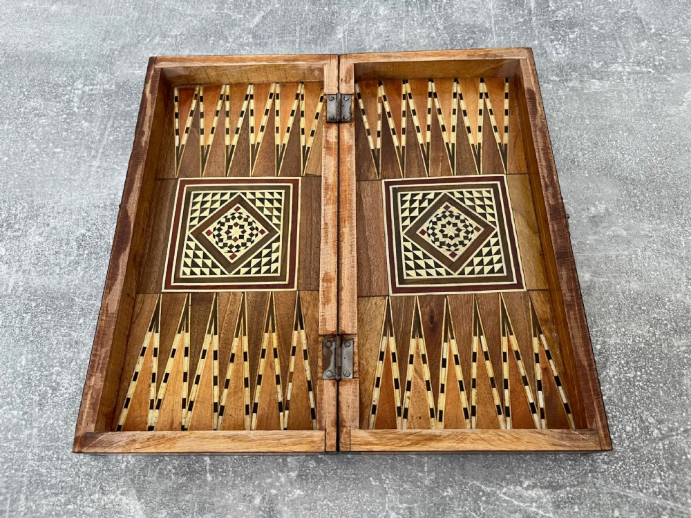 A hinged wooden folding games board featuring intricate geometric micro-mosaic marquetry and mother-of-pearl star motifs. View VII