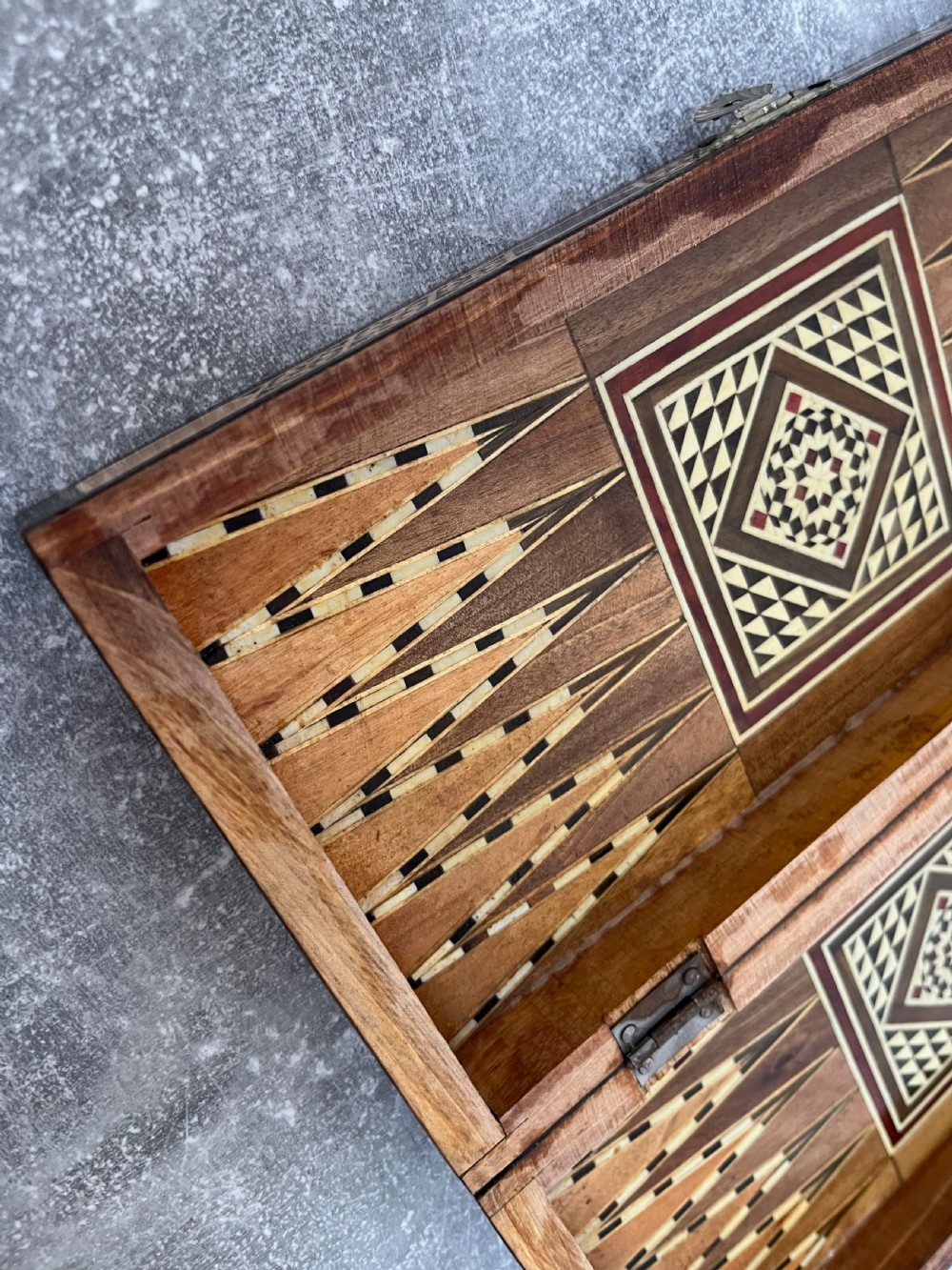 A hinged wooden folding games board featuring intricate geometric micro-mosaic marquetry and mother-of-pearl star motifs. View VIII