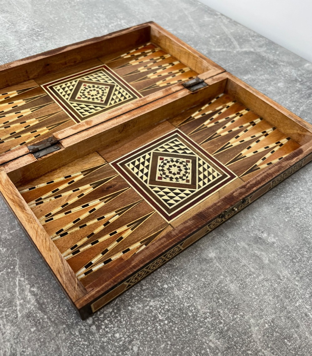 A hinged wooden folding games board featuring intricate geometric micro-mosaic marquetry and mother-of-pearl star motifs. View IX