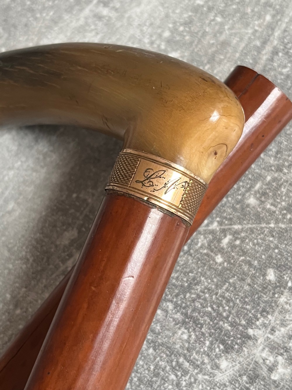 An antique French sword stick featuring an L-shaped horn handle, a gold-coloured engraved collar, a dark wooden sheath, and a slender unsheathed steel blade. View VIII