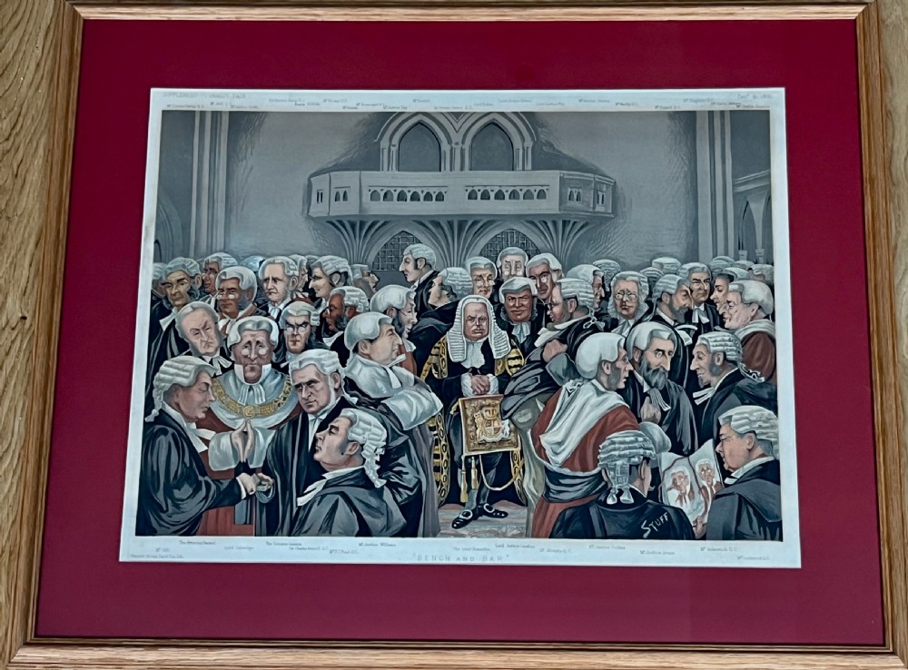 A framed late Victorian lithographic print entitled Bench and Bar featuring a crowd of barristers and judges in traditional wigs and gowns framed in light wood with a burgundy mount. View II