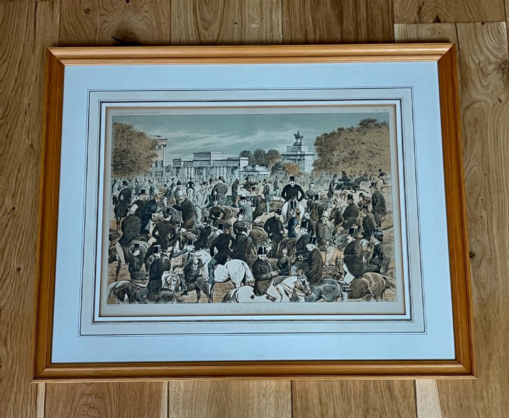 A framed Victorian colour lithograph depicting an equestrian crowd in Hyde Park London set within a light wood frame and wash line mount.