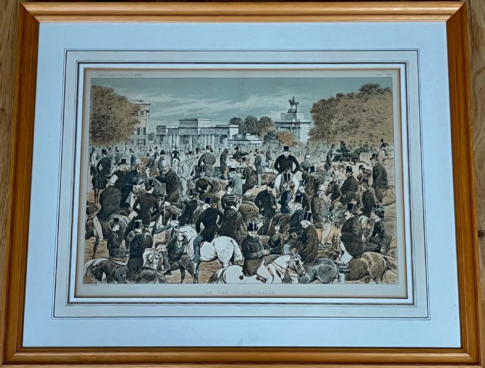 A framed Victorian colour lithograph depicting an equestrian crowd in Hyde Park London set within a light wood frame and wash line mount. View II
