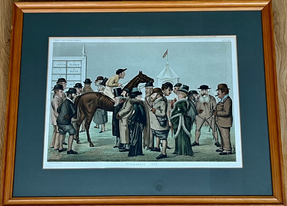 A Victorian framed Vanity Fair chromolithograph print titled Newmarket 1885 depicting an equestrian caricature scene inside a dark green mount and light wood frame. View II