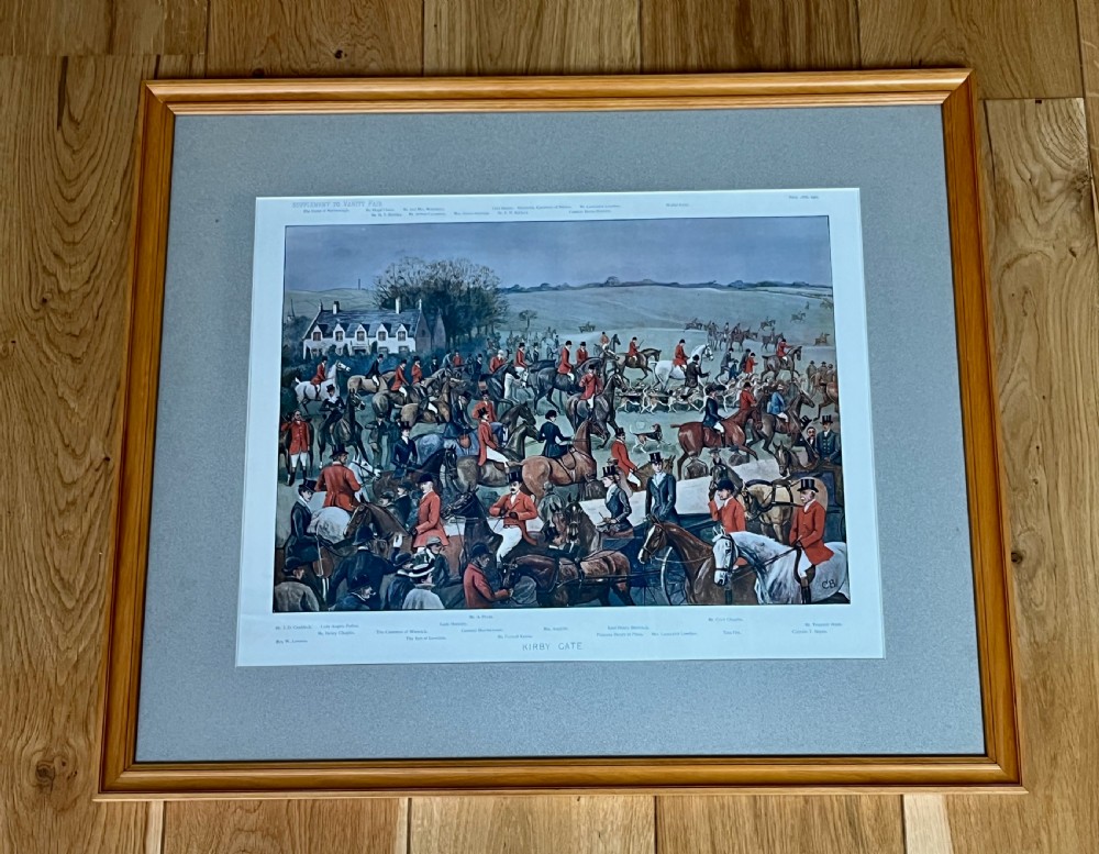 A framed Vanity Fair colour lithograph depicting five gentlemen in traditional red hunting attire set against a blue backdrop within a green card mount and simple wooden frame. View IV