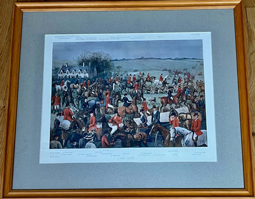 A framed Vanity Fair colour lithograph depicting five gentlemen in traditional red hunting attire set against a blue backdrop within a green card mount and simple wooden frame. View VI