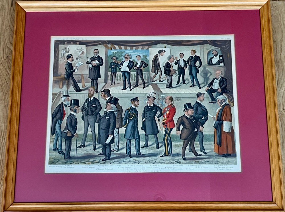 A framed Victorian Vanity Fair chromolithograph featuring group caricatures of late nineteenth-century figures, presented with a dark magenta mount and a light wood frame. View II