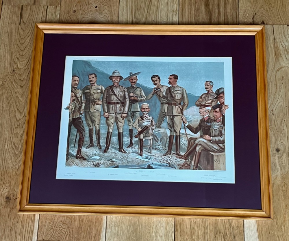 A framed Victorian Vanity Fair chromolithograph featuring group caricatures of late nineteenth-century figures, presented with a dark magenta mount and a light wood frame. View VII