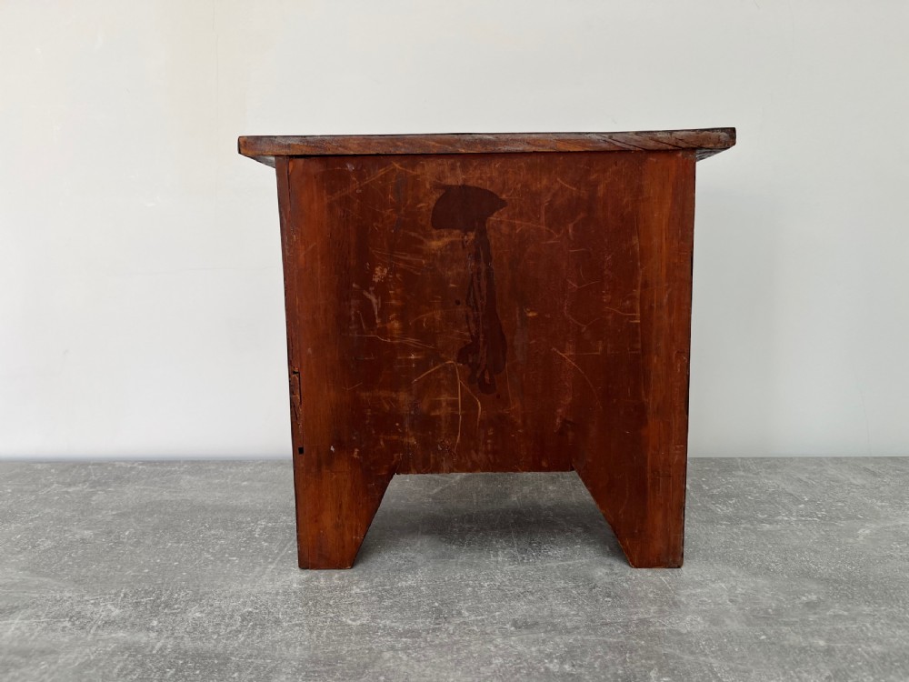 A miniature mahogany chest of drawers featuring three graduated drawers with turned wooden knobs and a shaped scalloped apron. View IX