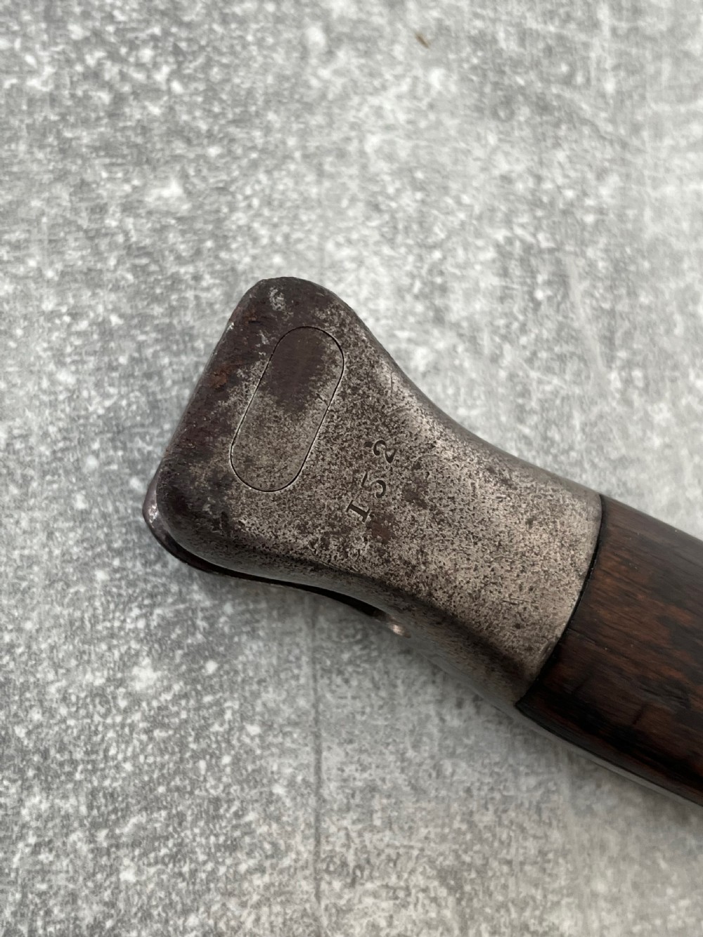 A Victorian British Pattern 1888 Mark 1 Type 2 sword bayonet with a double-edged steel blade, wooden handle grips secured with brass rivets, alongside its dark leather and steel-mounted scabbard. View VI