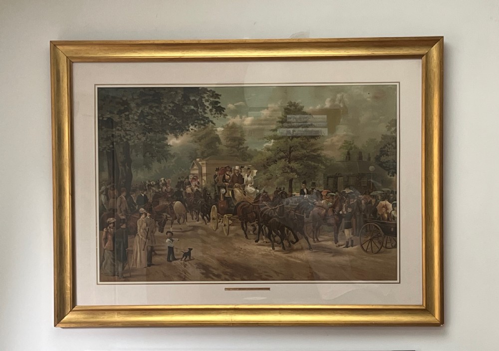 A framed 1885 colour lithograph titled The Meet of the Four-in-Hand Club depicting Victorian figures, horse-drawn carriages, and spectators in a park setting. View II