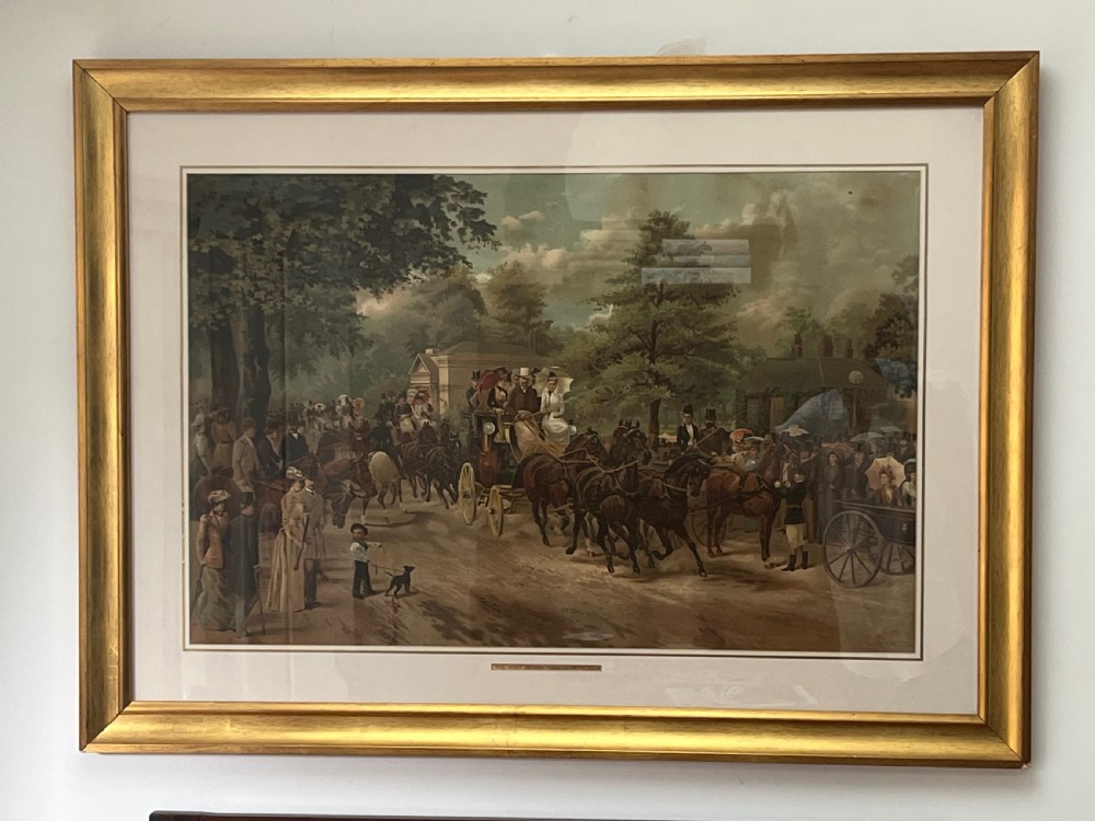 A framed 1885 colour lithograph titled The Meet of the Four-in-Hand Club depicting Victorian figures, horse-drawn carriages, and spectators in a park setting. View XII