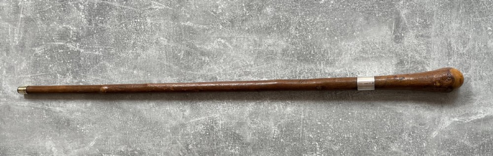 An antique chestnut wood sword stick shown unsheathed beside its shaft, featuring a root ball knob handle, silver collar mount, and long steel blade. View XV