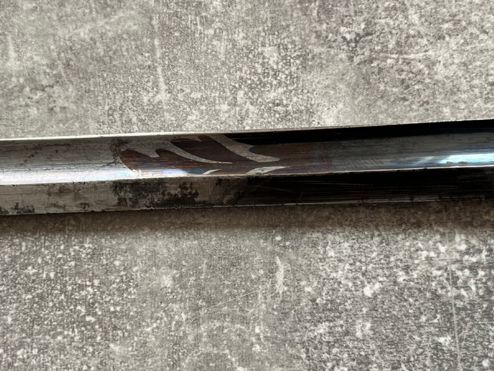 An antique sword stick with a dark brown leather-covered shaft, a silver knop top, and a partially drawn steel blade decorated with gold-toned etchings. View VII