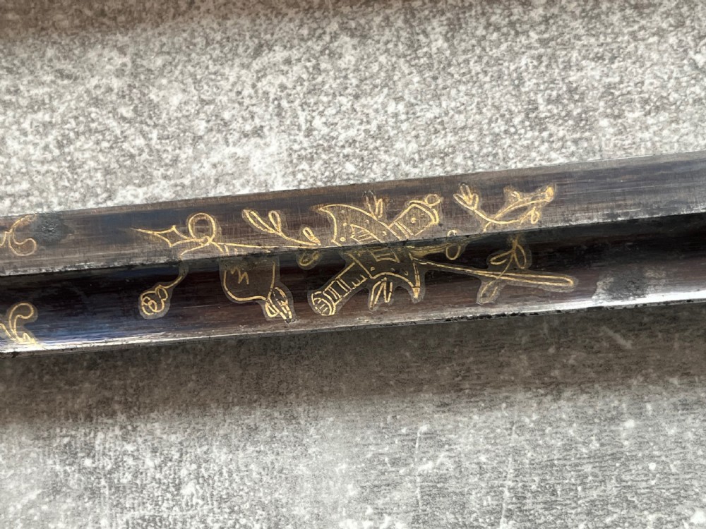 An antique sword stick with a dark brown leather-covered shaft, a silver knop top, and a partially drawn steel blade decorated with gold-toned etchings. View IX