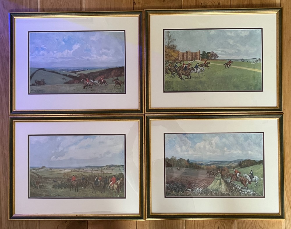 A set of four framed colour prints depicting fox hunting scenes in cream mounts and dark wood frames with gilt trim.