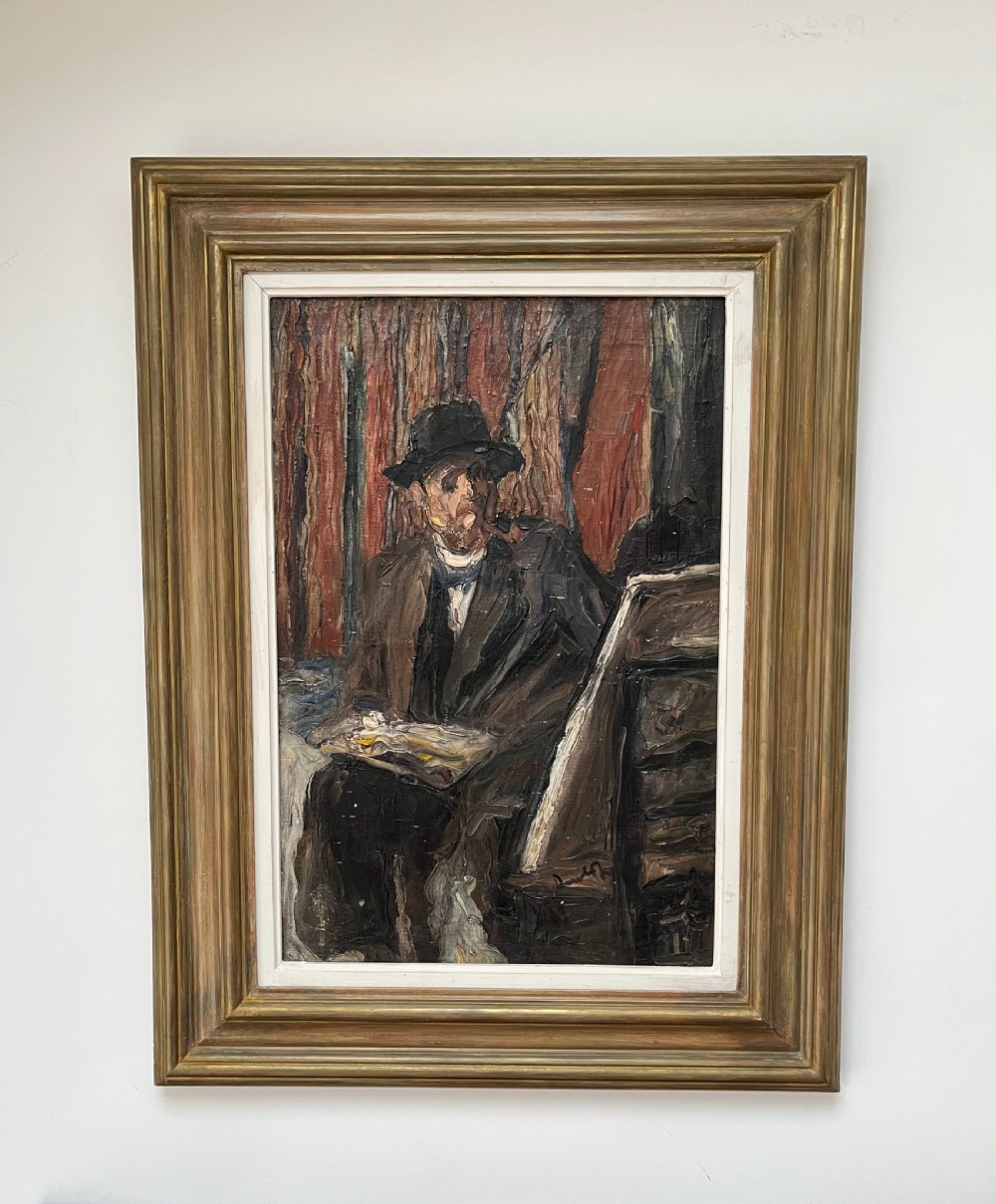 A framed post-impressionist oil painting depicting a seated artist wearing a hat while holding a palette.