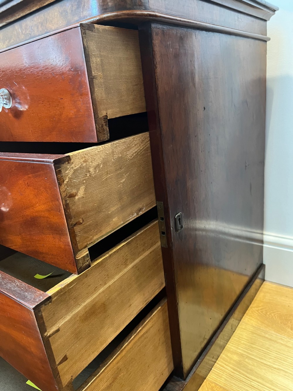 A matching pair of antique burr walnut bedside cabinets featuring single door cupboards with recessed arched panels and plinth bases. View VII