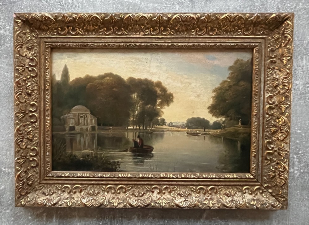 A 19th-century oil painting on board depicting figures in a rowboat on a calm river flanked by trees and classic architecture, housed in an ornate giltwood frame. View IX