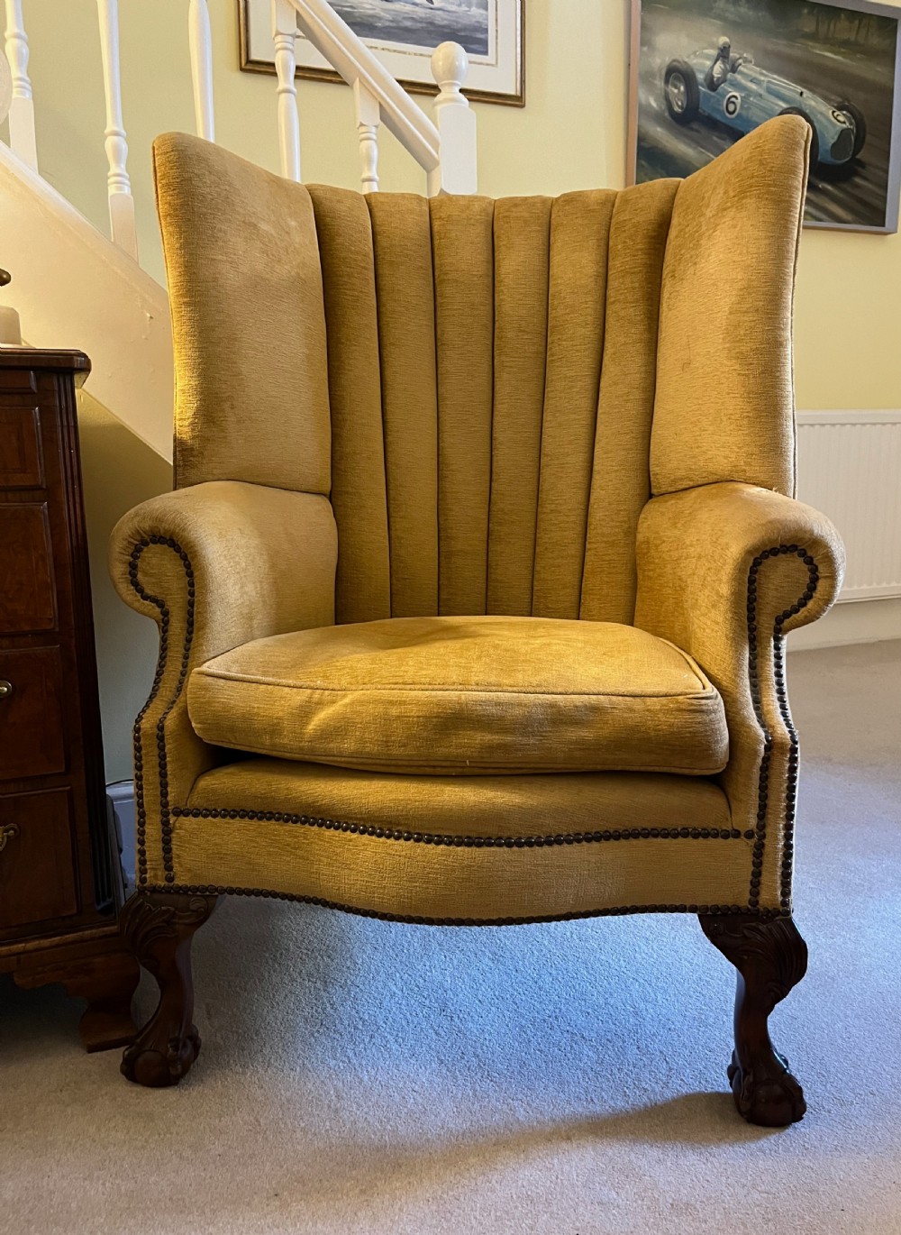 An Edwardian barrel back armchair upholstered in gold velvet with vertical fluted stitching, metal stud detailing, and carved dark wood legs. View IV