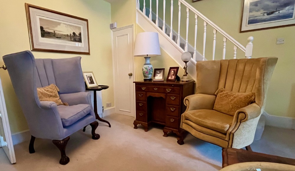 A high-backed Victorian barrel back armchair upholstered in light grey fabric, featuring channel-tufted back detailing and dark carved cabriole legs with ball and claw feet. View XI