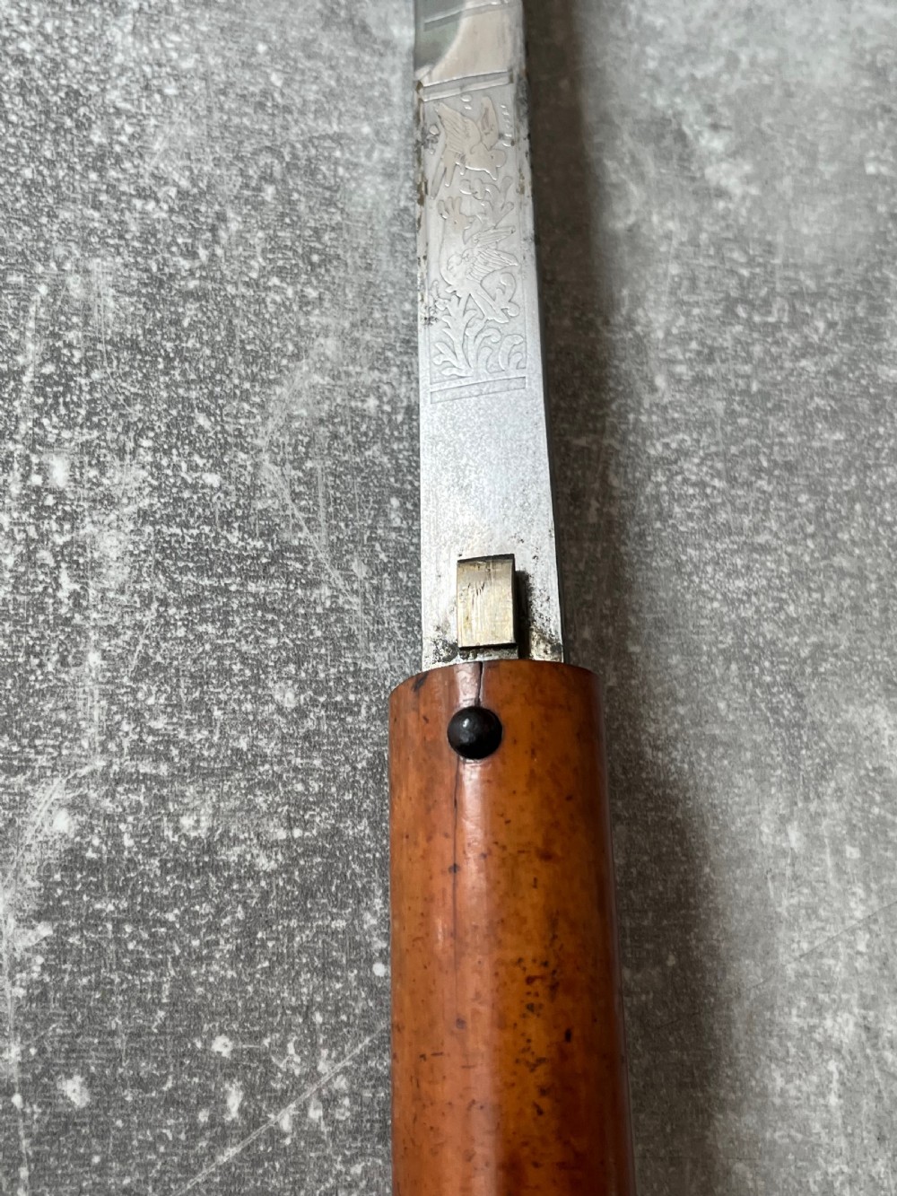An antique Malacca wood walking stick unsheathed to reveal an etched steel Toledo blade alongside a silver collar and horn handle. View XIII