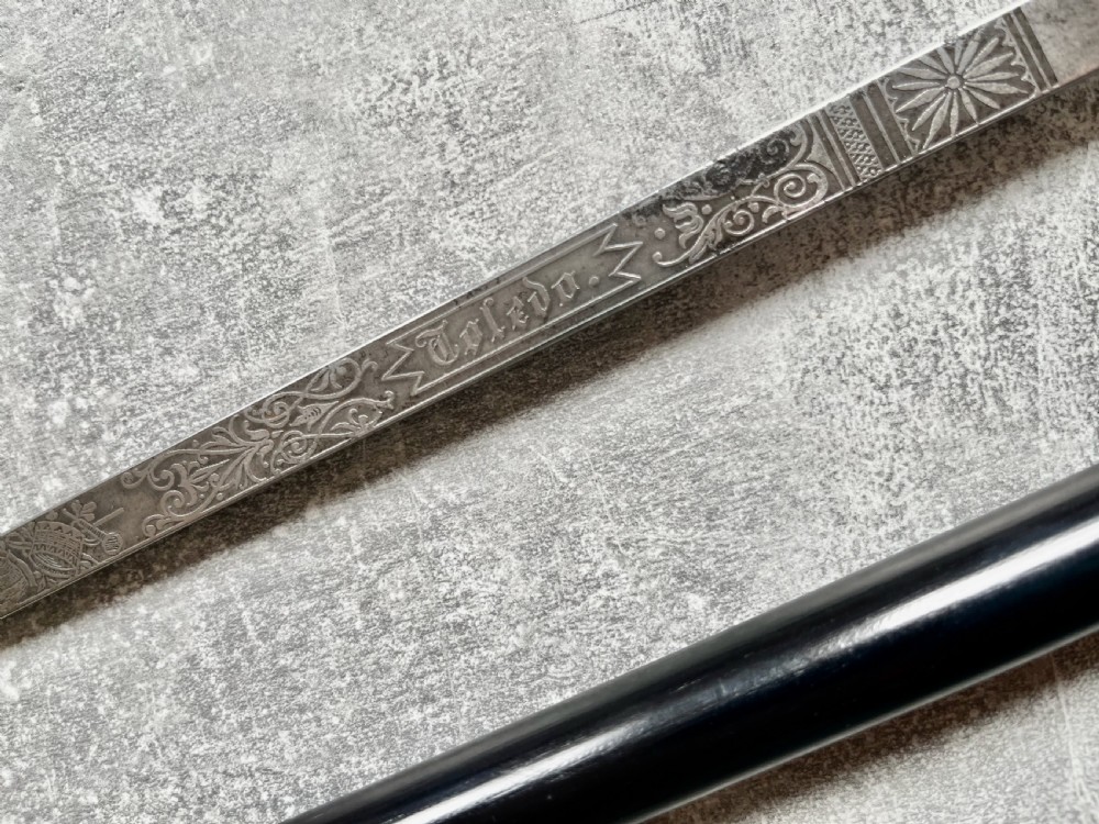 A Victorian ebonised wood walking stick shown in two parts alongside a slender concealed steel Toledo blade. View V
