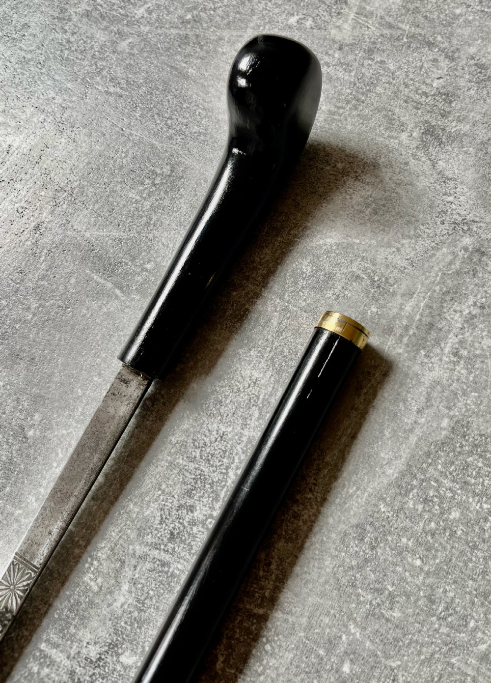 A Victorian ebonised wood walking stick shown in two parts alongside a slender concealed steel Toledo blade. View XII