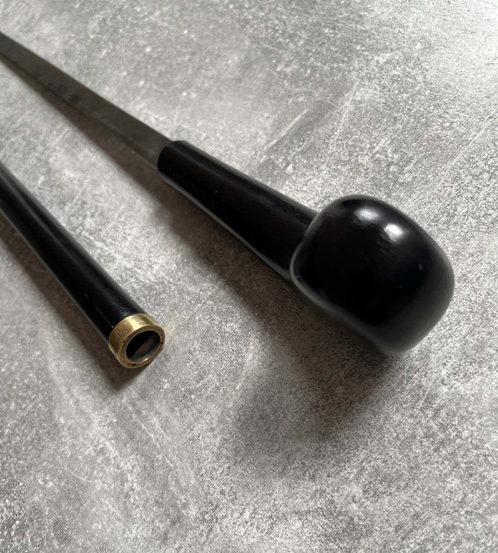 A Victorian ebonised wood walking stick shown in two parts alongside a slender concealed steel Toledo blade. View XIII