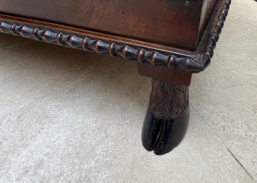 A pair of antique Regency mahogany side cabinets featuring brass lattice glazed doors and carved cloven hoof feet. View V