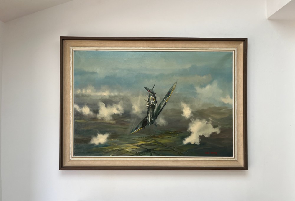 A framed oil painting on canvas depicting a Supermarine Spitfire aircraft diving through clouds over a green countryside landscape, signed by artist Dion Pears. View III