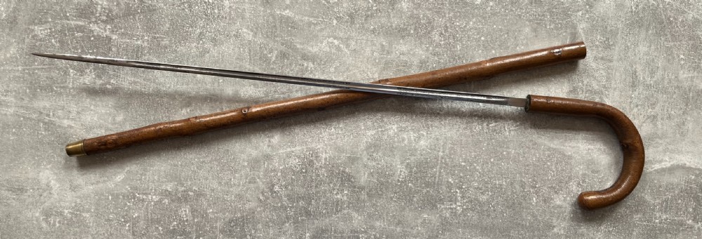 An antique hazel wood crook-handled walking stick shown unsheathed beside its concealed etched steel blade. View XIII