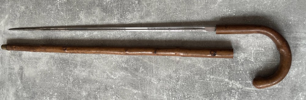 An antique hazel wood crook-handled walking stick shown unsheathed beside its concealed etched steel blade. View XIV