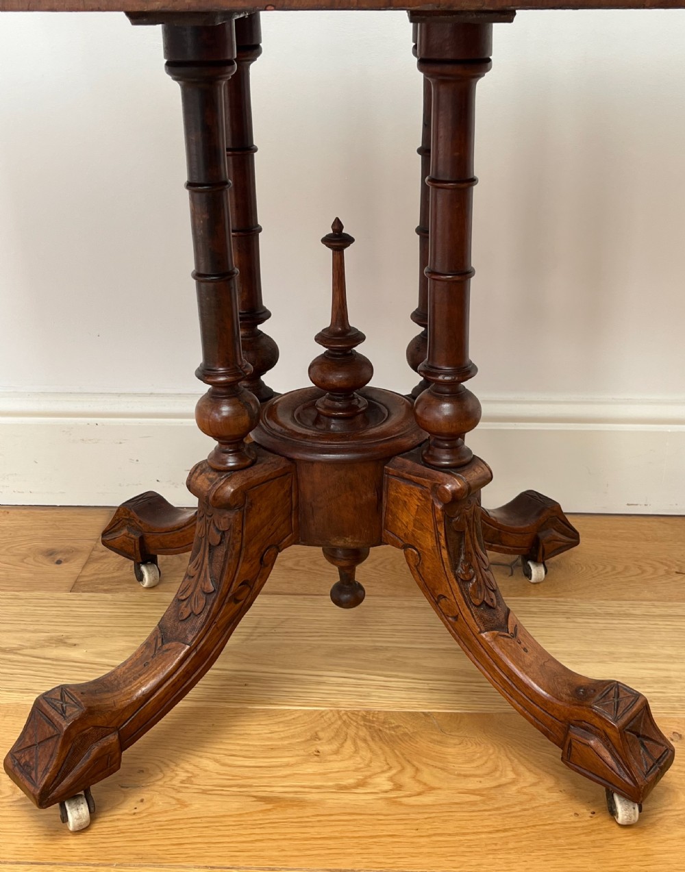 A Victorian burr walnut card table with an unfolded green baize surface resting on a carved pedestal base. View VII
