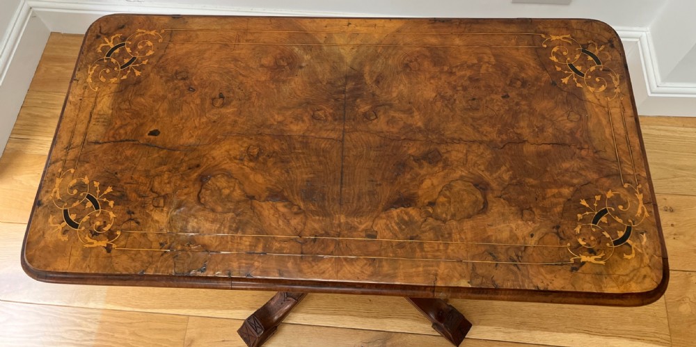 A Victorian burr walnut card table with an unfolded green baize surface resting on a carved pedestal base. View XI