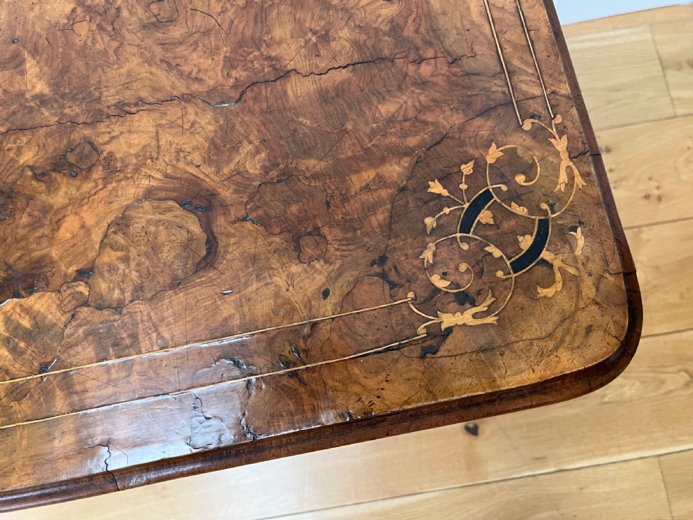 A Victorian burr walnut card table with an unfolded green baize surface resting on a carved pedestal base. View XII