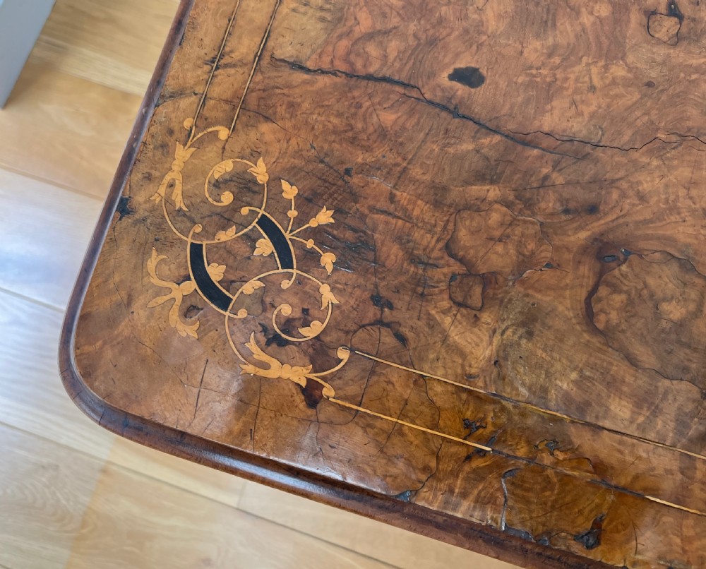 A Victorian burr walnut card table with an unfolded green baize surface resting on a carved pedestal base. View XIII