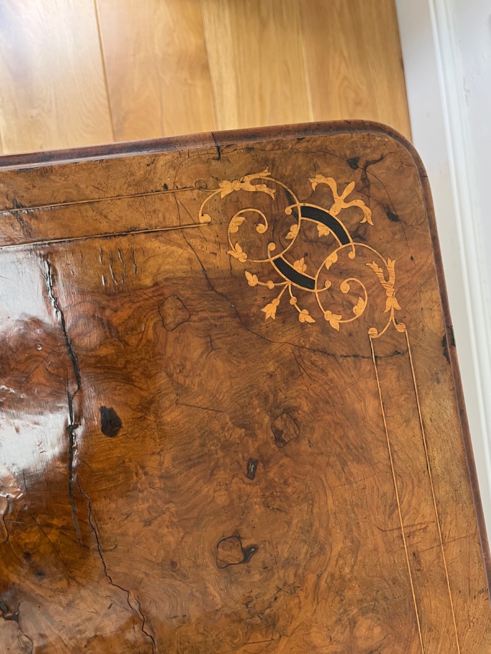 A Victorian burr walnut card table with an unfolded green baize surface resting on a carved pedestal base. View XIV