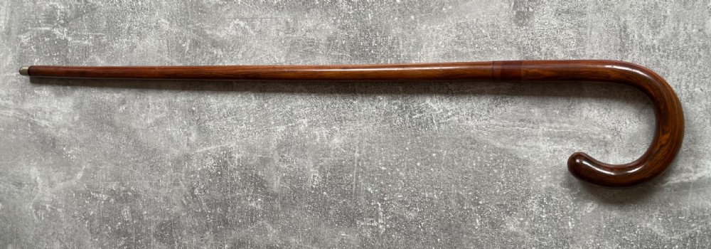 An antique brown Malacca wood walking stick with a curved crook handle, shown unsheathed to reveal an etched steel Toledo blade alongside its wooden sheath. View XV