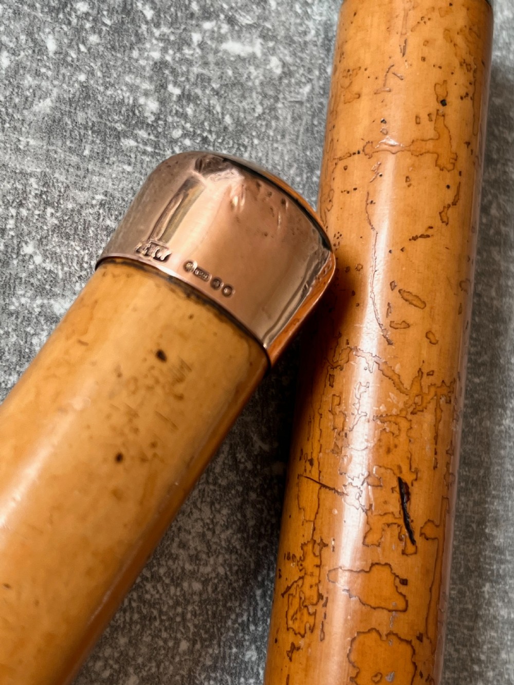 An antique malacca walking cane separated to reveal a tapered steel sword blade with silver and gold mounts. View V