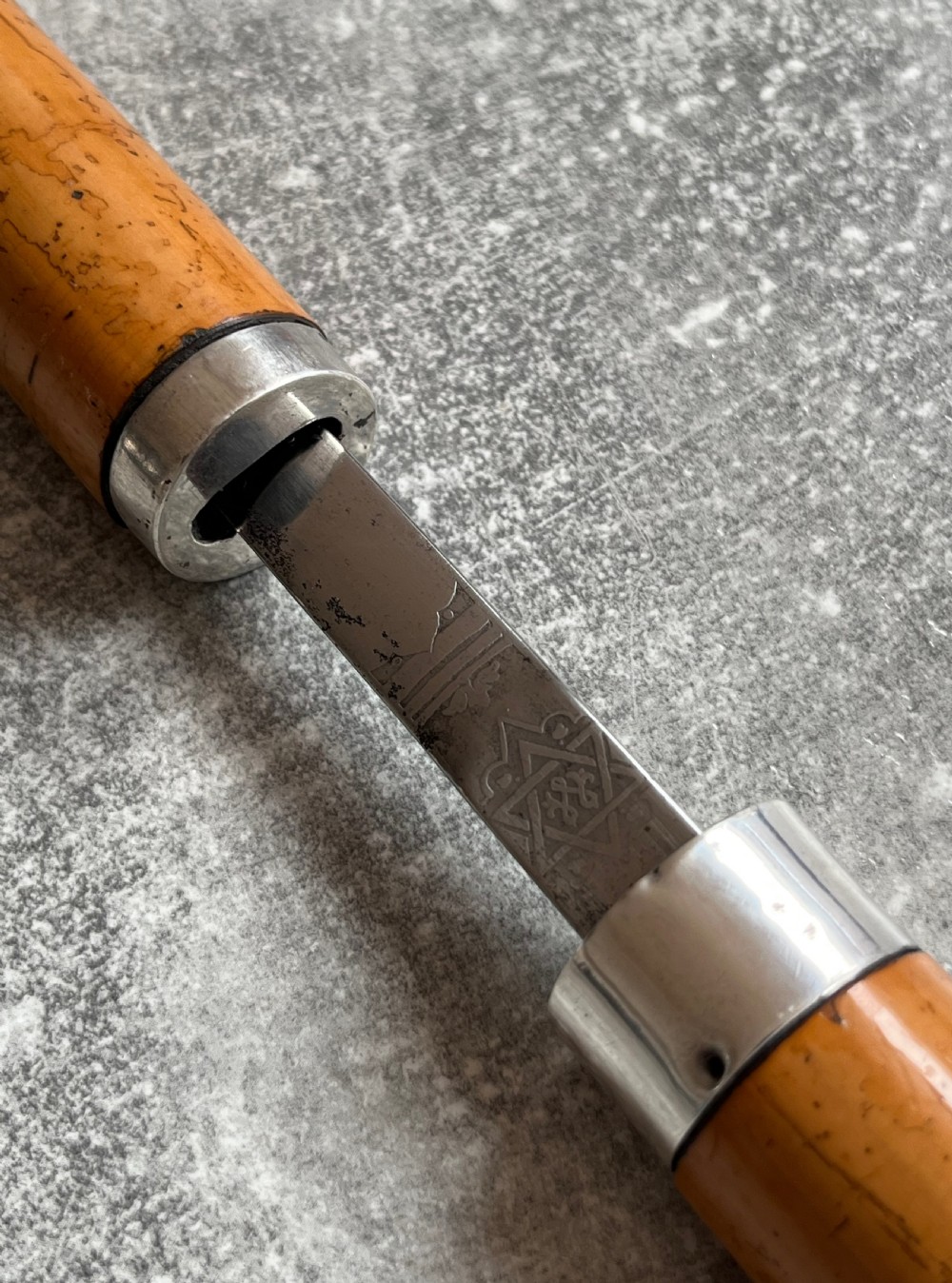 An antique malacca walking cane separated to reveal a tapered steel sword blade with silver and gold mounts. View VI
