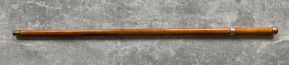 An antique malacca walking cane separated to reveal a tapered steel sword blade with silver and gold mounts. View XIV