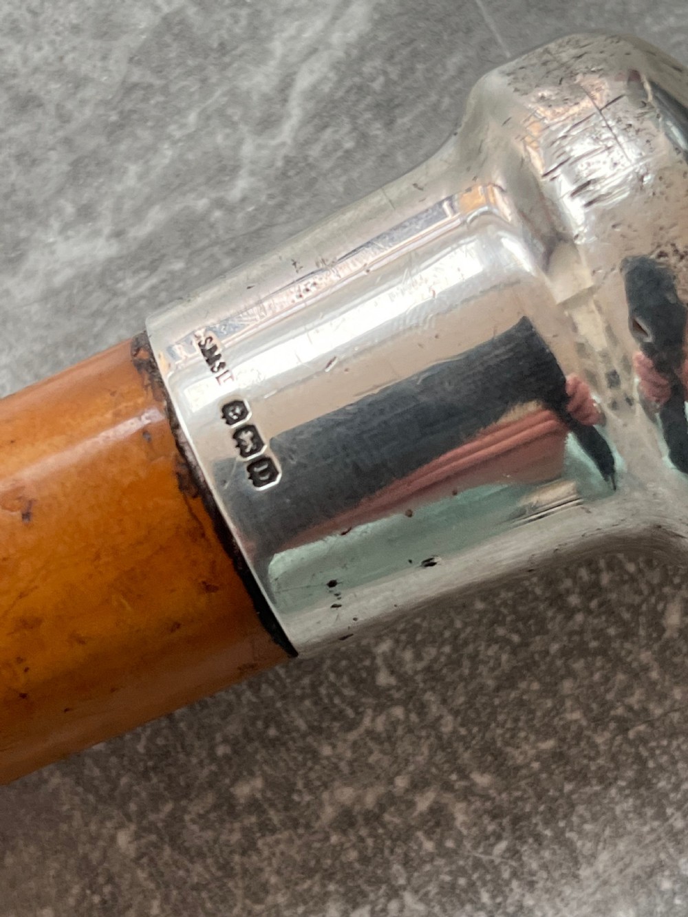 An antique malacca cane sword stick featuring a hallmarked silver pommel collar and an etched steel blade alongside its wooden sheath. View VII