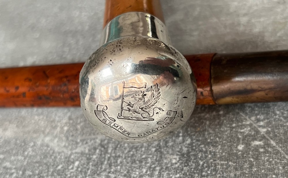 An antique malacca cane sword stick featuring a hallmarked silver pommel collar and an etched steel blade alongside its wooden sheath. View XIV