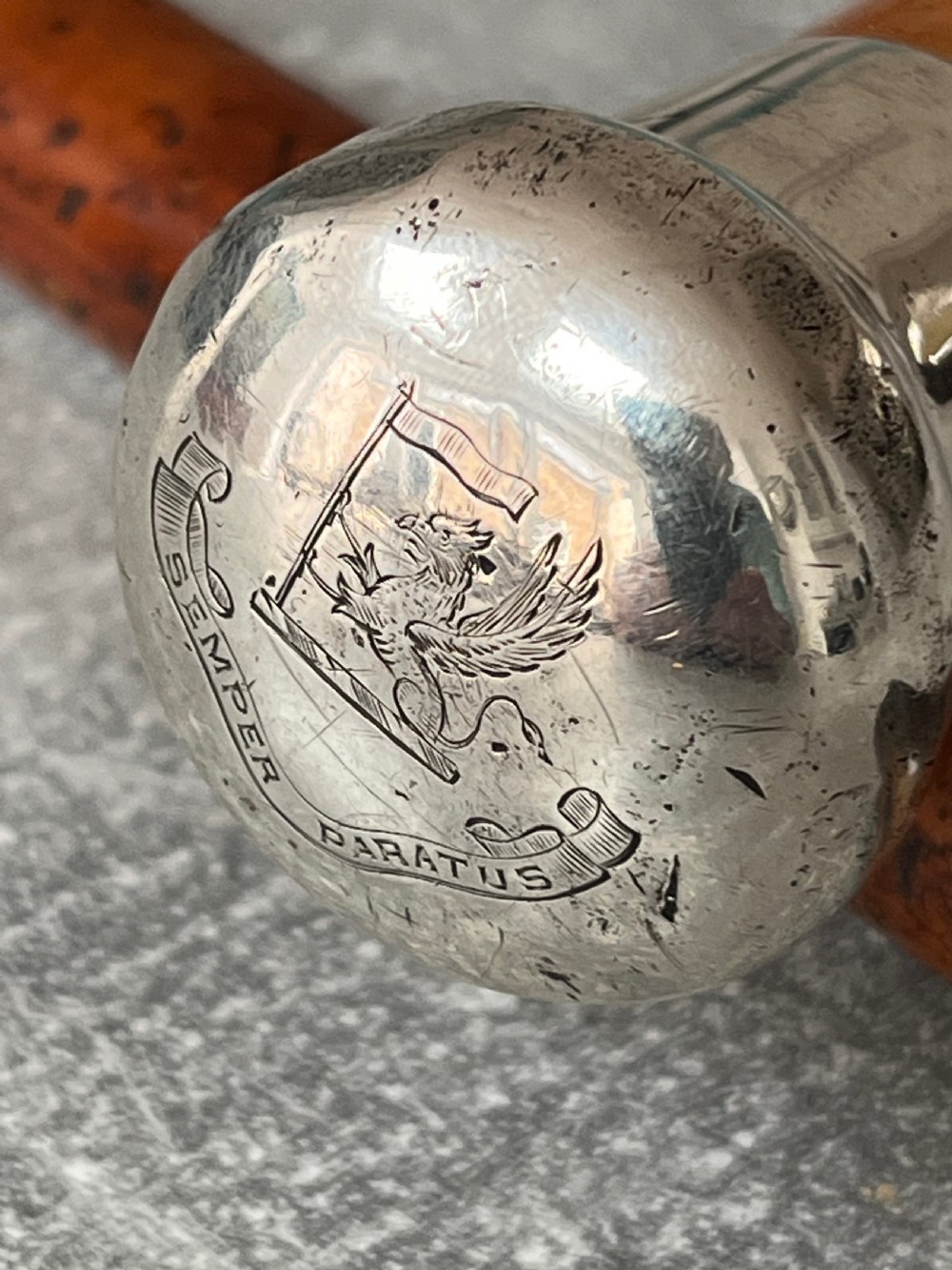 An antique malacca cane sword stick featuring a hallmarked silver pommel collar and an etched steel blade alongside its wooden sheath. View XV