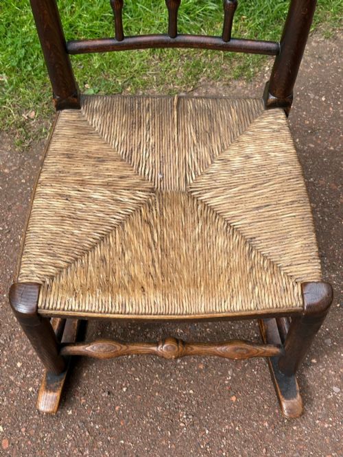 A SMALL GEORGE III LANCASHIRECHESHIRE STAINED ASH AND WOVEN RUSH ROCKING CHAIR - ADDITIONAL PHOTO 1